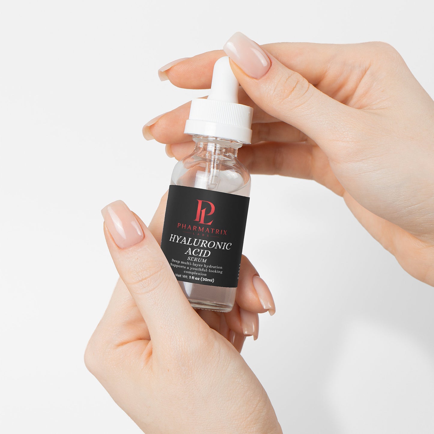 Hand holding a bottle of Pharmatrix Labs Hyaluronic Acid Serum against a light background